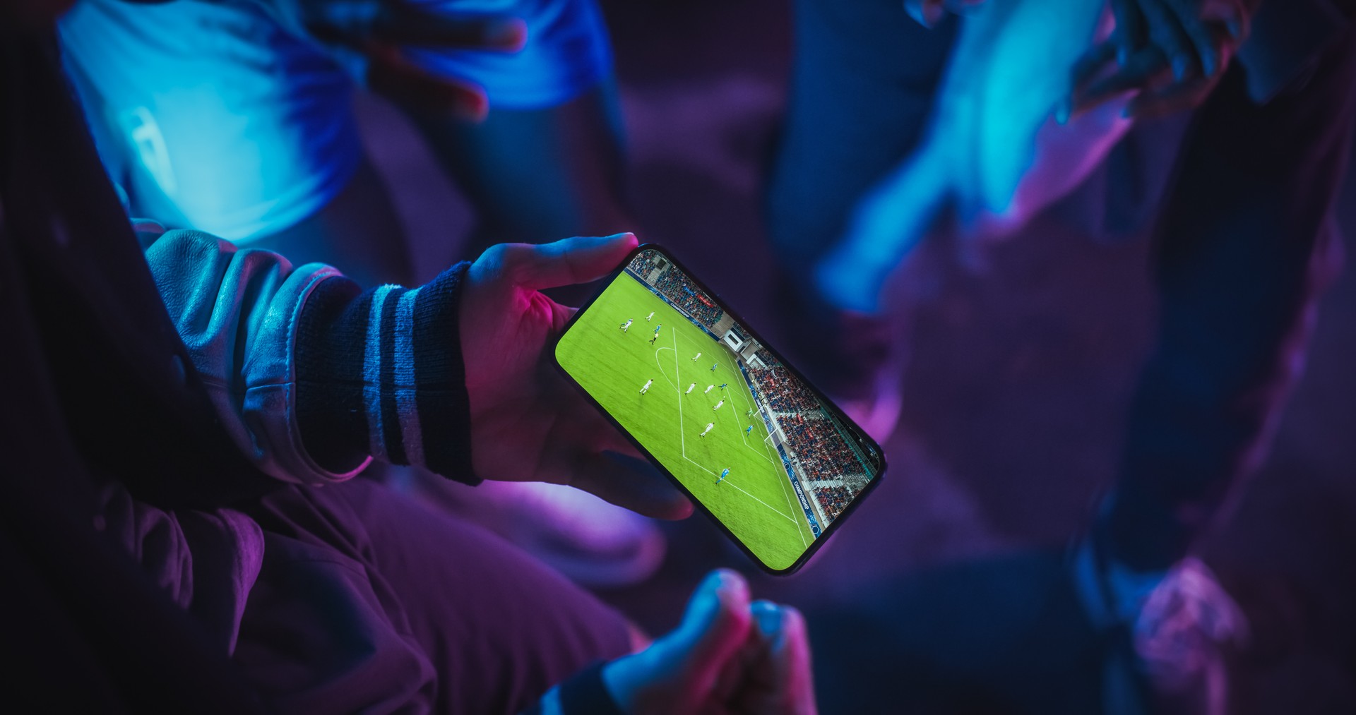 Close Up Smartphone Screen with a Soccer Championship Live Broadcast. Group of People Using the Mobile Phone, Following a Sports Internet Stream, Supporting Their Football Team